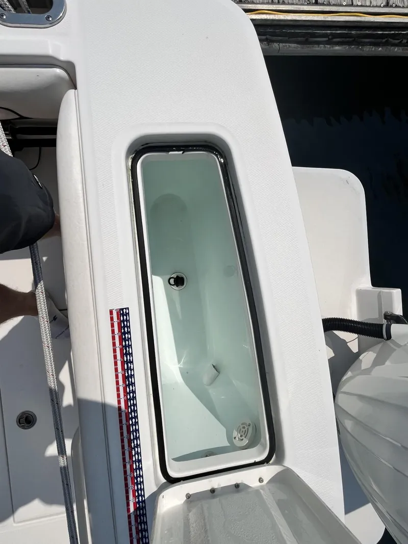 Slide: The Image of Livewell on a 2016 Regulator 23 boat, featuring a clean, white interior. - 13