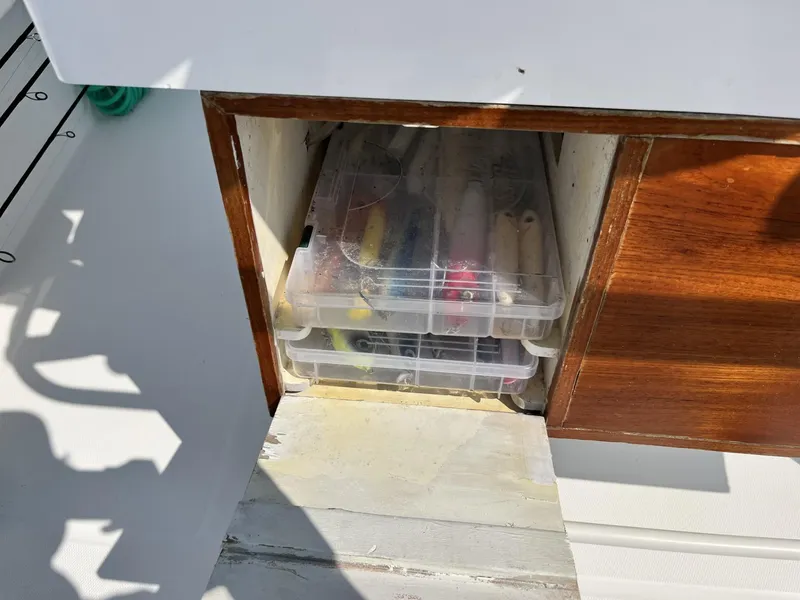 Slide: The Image of Storage compartment on a 2016 Regulator 23 boat with organized fishing tackle boxes. - 20