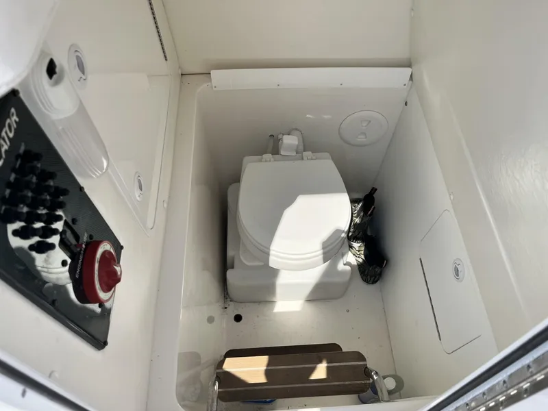 Slide: The Image of Compact marine toilet in a 2016 Regulator 23 boat cabin. - 28