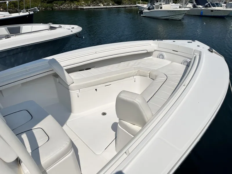 Slide: The Image of 2016 Regulator 23 boat with white seating, docked in calm waters. - 29