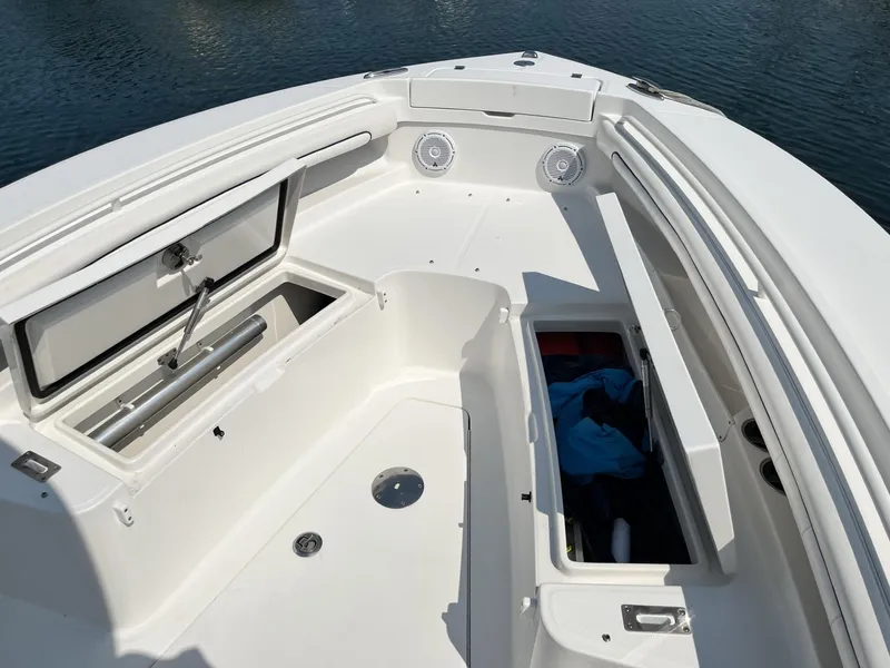 Slide: The Image of 2016 Regulator 23 boat interior with open storage compartments on calm water. - 39