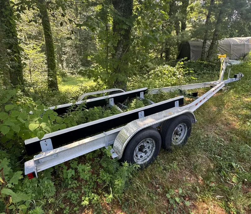 Slide: The Image of Trailer for 2016 Regulator 23 boat, parked in a wooded area. - 45