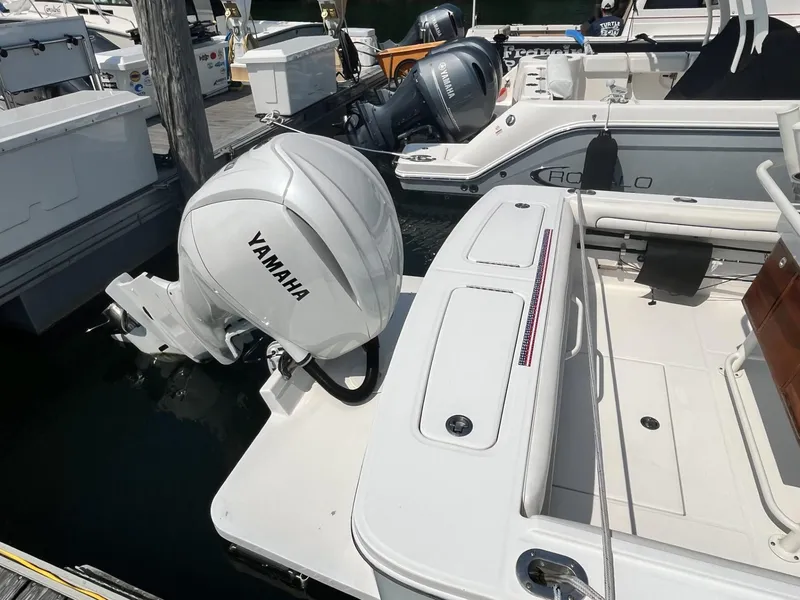 Slide: The Image of 2016 Regulator 23 boat with Yamaha outboard motor docked at marina. - 8