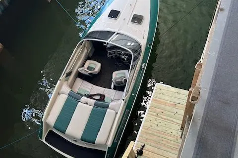 Slide: The Image of 1988 Sea Ray Pachanga 22 boat docked, aerial view, green and white design. - 2