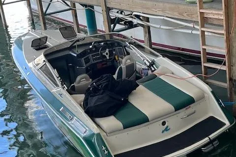 Slide: The Image of 1988 Sea Ray Pachanga 22 boat docked, featuring green and white upholstery. - 7