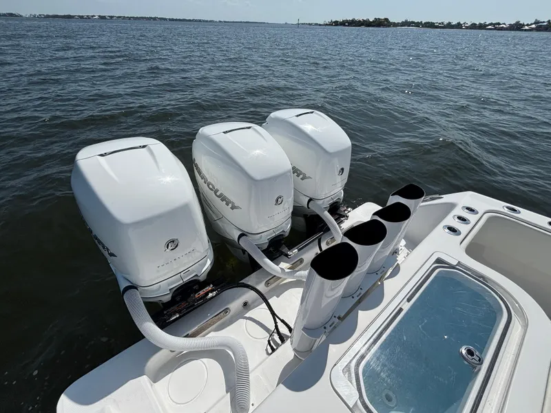 Slide: The Image of 2022 Invincible 36 Open Fisherman with triple Mercury outboard engines on open water. - 12