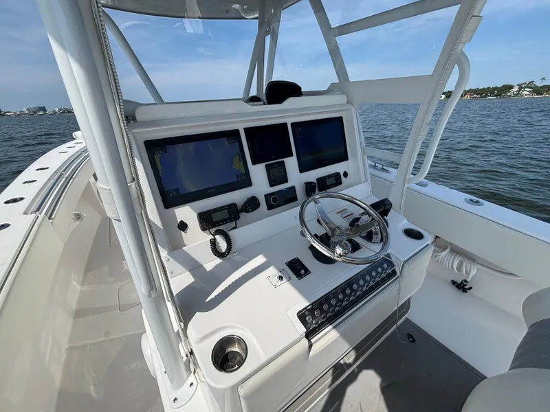 Slide: The Image of 2022 Invincible 36 Open Fisherman boat cockpit with navigation screens and steering wheel. - 13