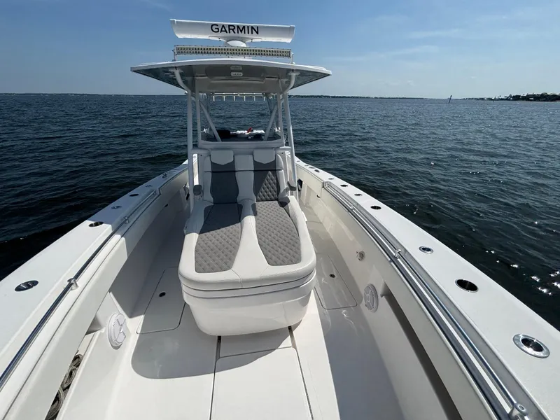 Slide: The Image of 2022 Invincible 36 Open Fisherman boat on open water, featuring Garmin equipment. - 20