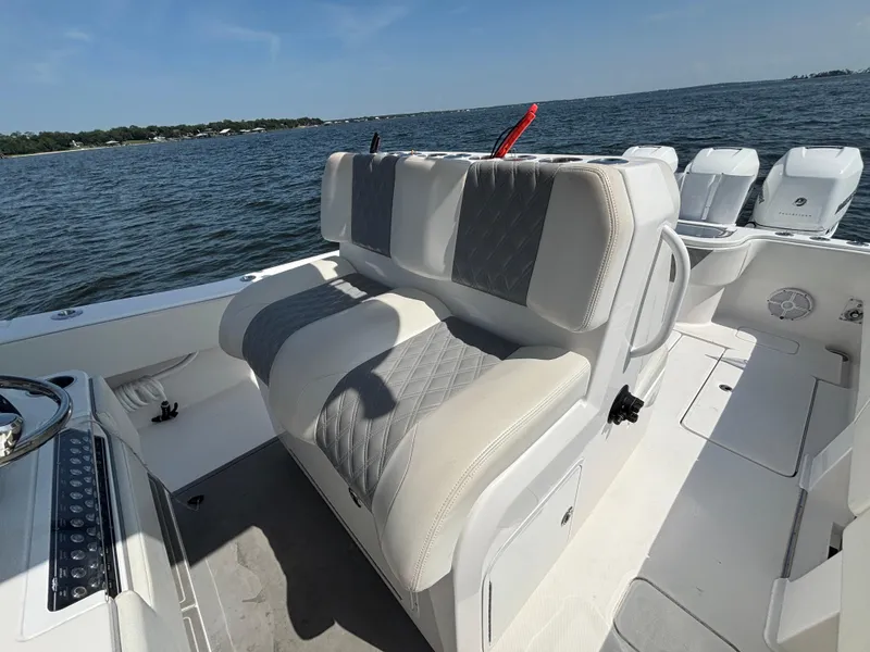 Slide: The Image of 2022 Invincible 36 Open Fisherman boat interior with cushioned seating and ocean view. - 21