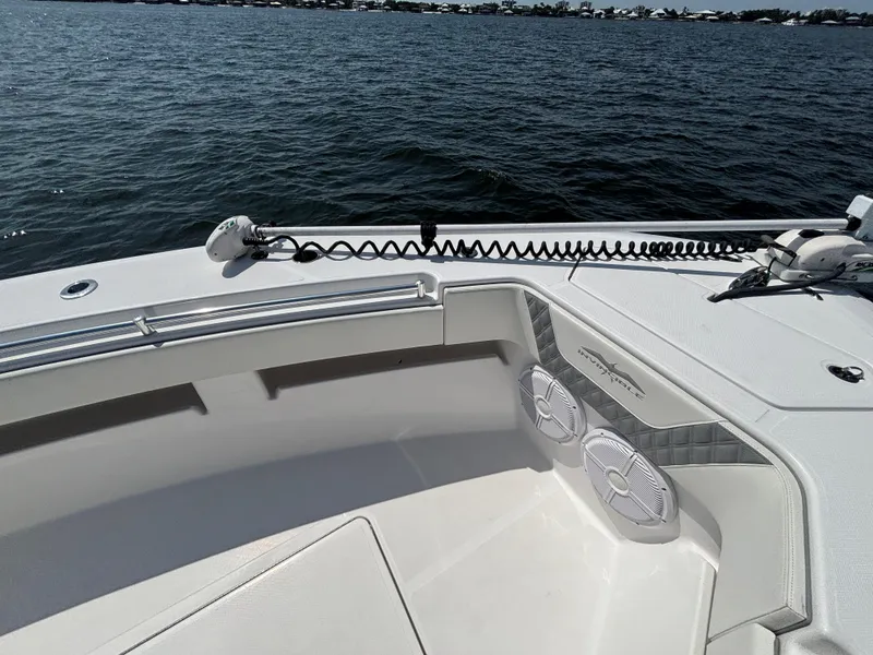 Slide: The Image of 2022 Invincible 36 Open Fisherman boat on water, featuring deck speakers and railing. - 22