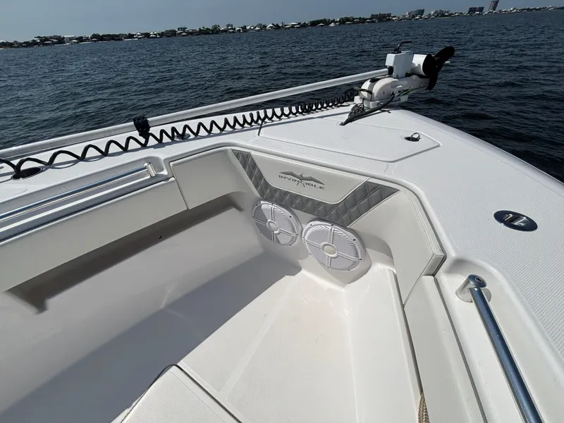 Slide: The Image of 2022 Invincible 36 Open Fisherman boat interior with speakers, on calm water. - 23