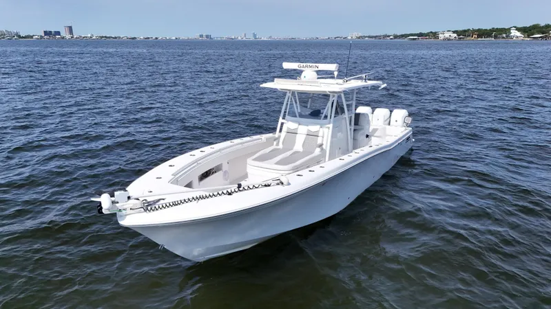 Slide: The Image of 2022 Invincible 36 Open Fisherman boat on calm water, featuring Garmin equipment. - 4