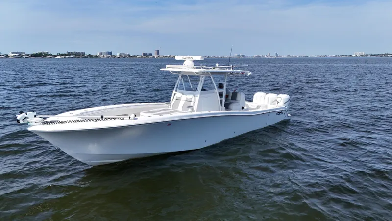 Slide: The Image of 2022 Invincible 36 Open Fisherman boat on calm waters, city skyline in background. - 6