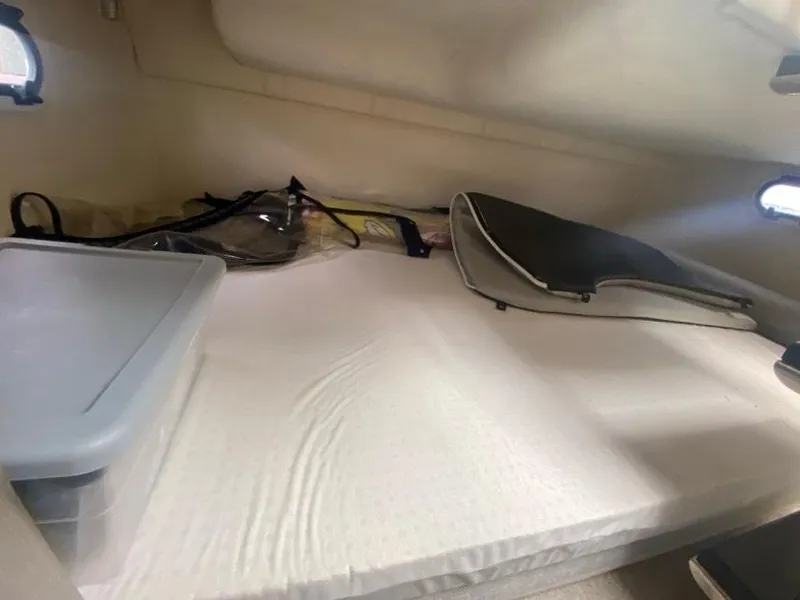 Slide: The Image of 2019 Regal 26 Express cabin interior with storage and bedding. - 11