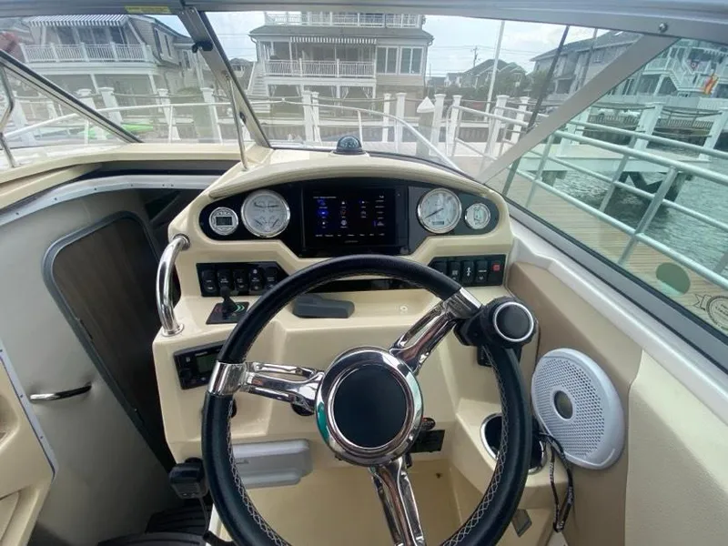 Slide: The Image of 2019 Regal 26 Express boat helm with steering wheel and control panel. - 7
