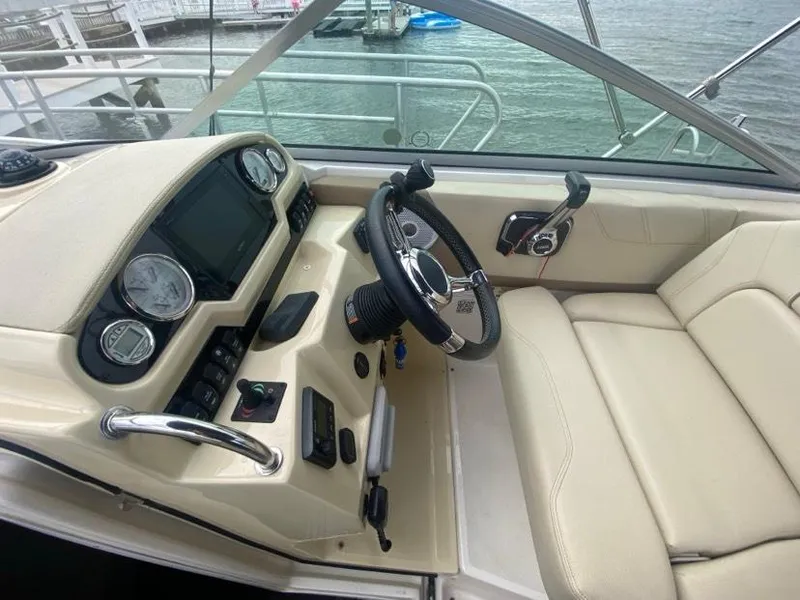 Slide: The Image of 2019 Regal 26 Express boat cockpit with steering wheel and control panel. - 8