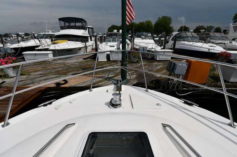Slide: The Image of 2001 Sea Ray 480 Sedan Bridge yacht docked at marina with other boats. - 1