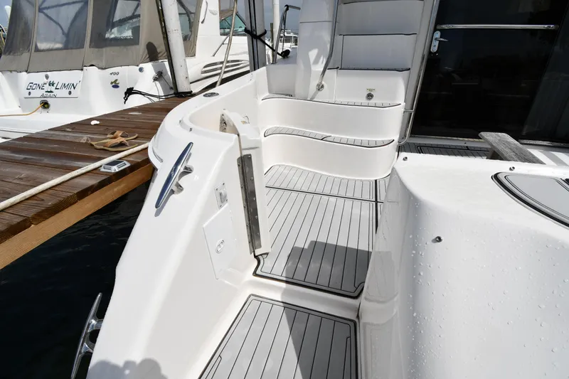 Slide: The Image of 2001 Sea Ray 480 Sedan Bridge yacht deck with sleek white seating and wood accents. - 15