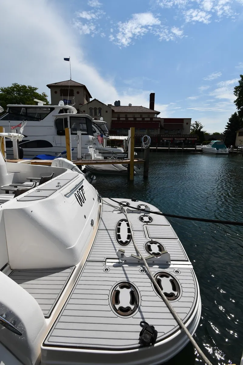 Slide: The Image of 2001 Sea Ray 480 Sedan Bridge docked at a marina under a partly cloudy sky. - 17