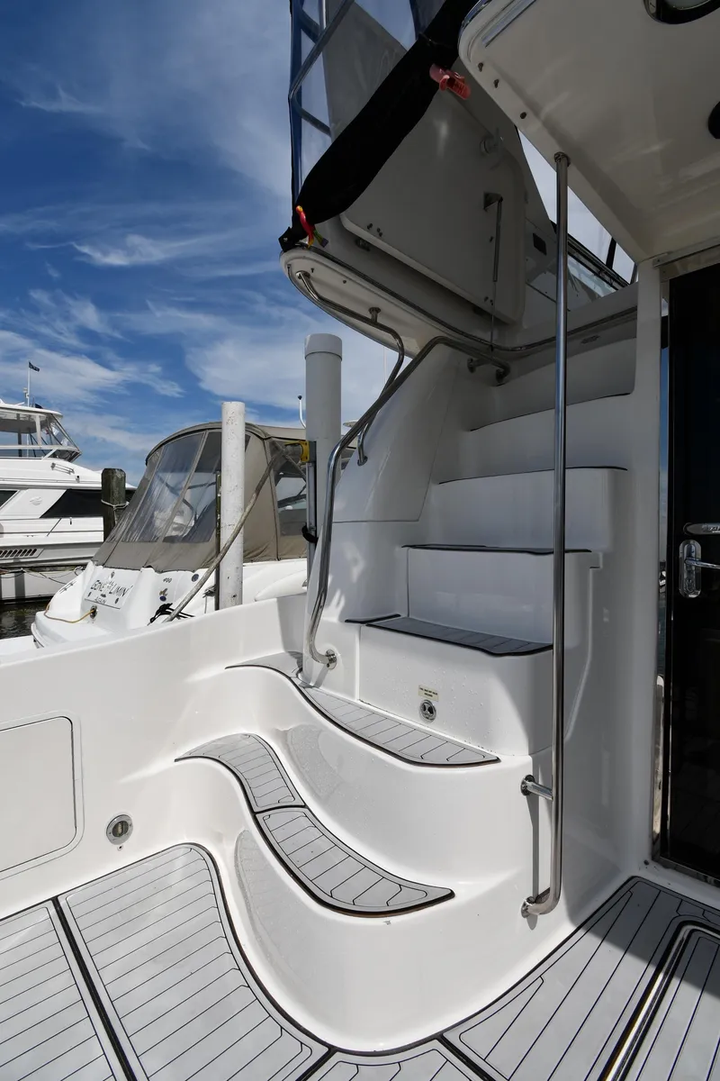 Slide: The Image of 2001 Sea Ray 480 Sedan Bridge yacht with elegant white stairs and sleek design. - 18