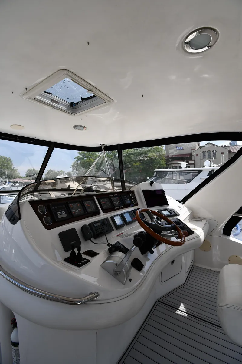 Slide: The Image of Interior view of 2001 Sea Ray 480 Sedan Bridge yacht cockpit with modern controls. - 20