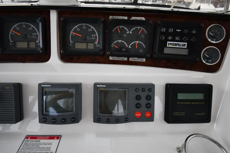 Slide: The Image of Control panel of a 2001 Sea Ray 480 Sedan Bridge with gauges and navigation equipment. - 22