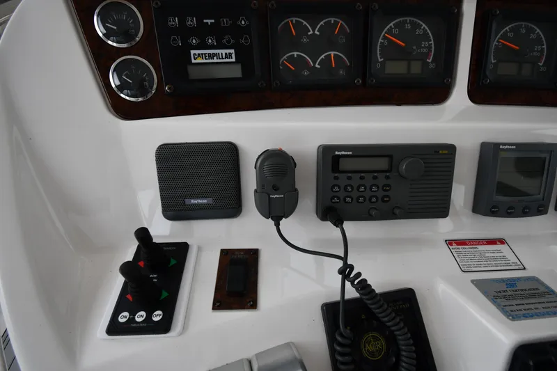 Slide: The Image of Control panel of a 2001 Sea Ray 480 Sedan Bridge with gauges and communication devices. - 23