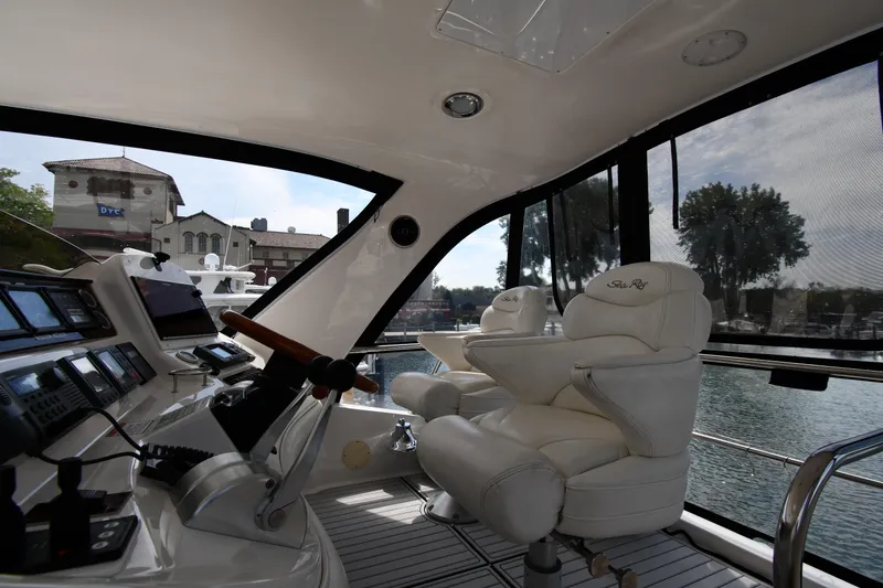 Slide: The Image of Interior view of 2001 Sea Ray 480 Sedan Bridge yacht with luxurious seating and control panel. - 24