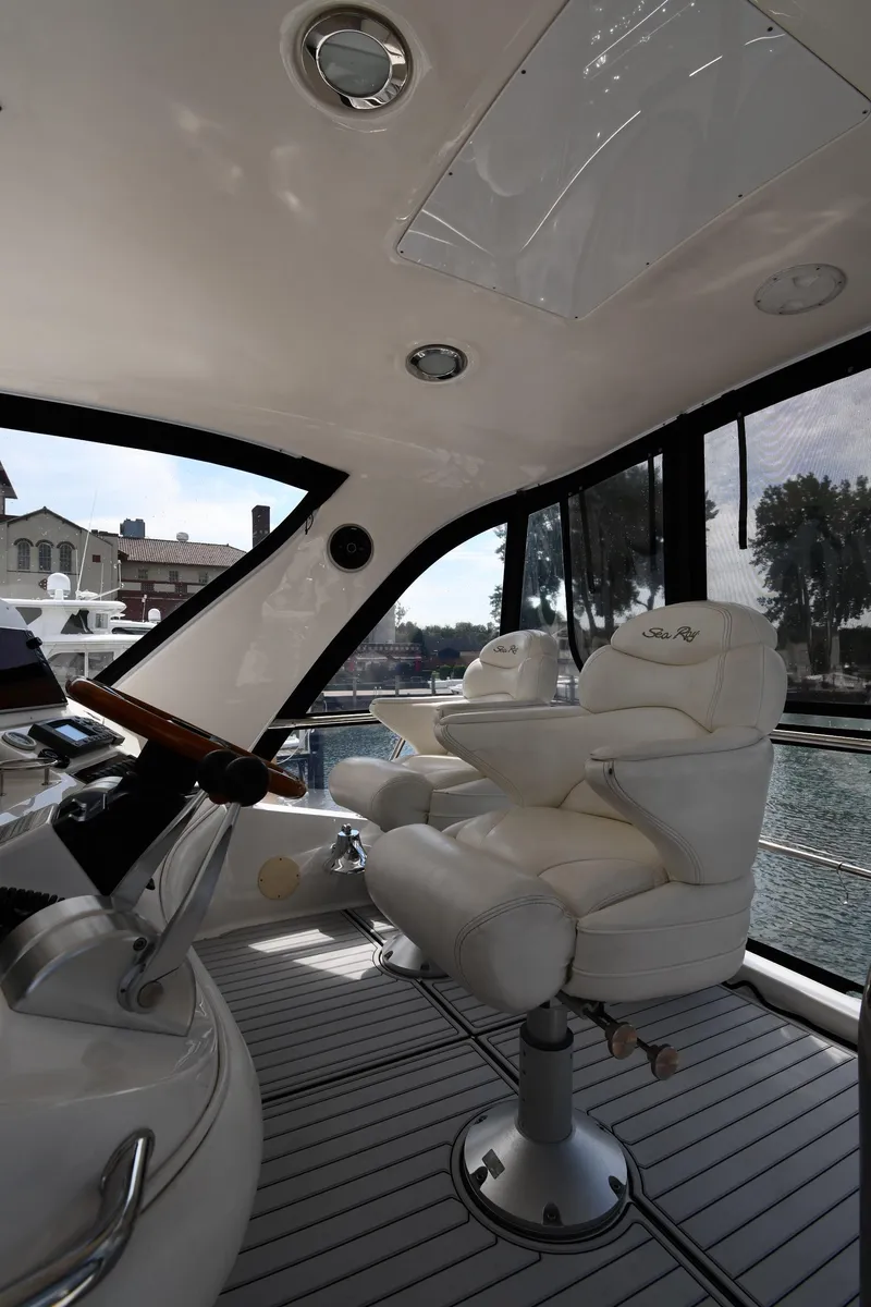 Slide: The Image of 2001 Sea Ray 480 Sedan Bridge interior with luxurious captain's chair and helm. - 25