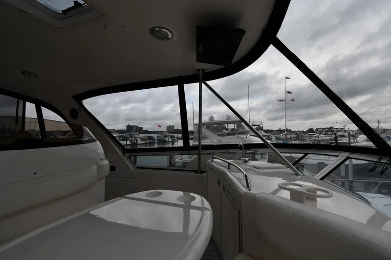 Slide: The Image of Interior view of 2001 Sea Ray 480 Sedan Bridge yacht with marina backdrop. - 26