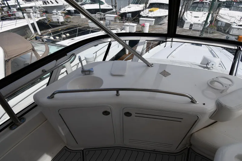 Slide: The Image of 2001 Sea Ray 480 Sedan Bridge yacht interior with sink and seating, docked at marina. - 28