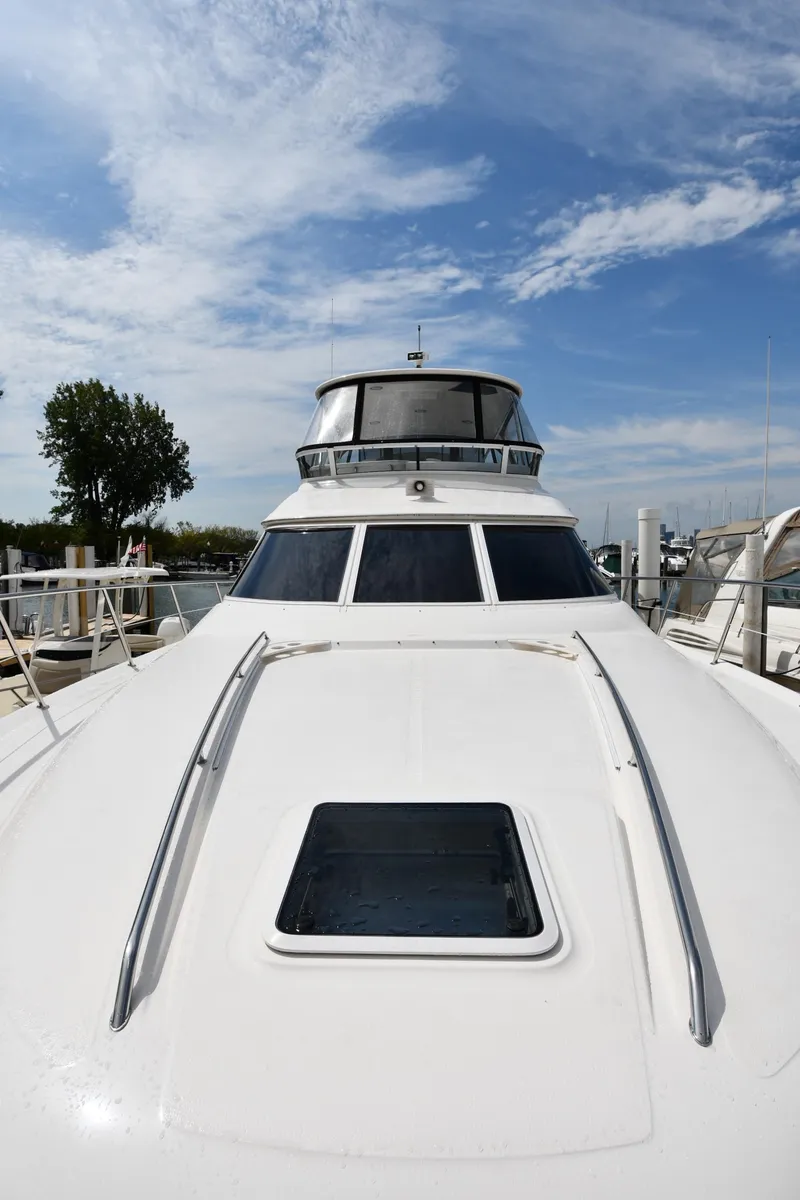 Slide: The Image of 2001 Sea Ray 480 Sedan Bridge yacht with sleek design under a clear blue sky. - 3