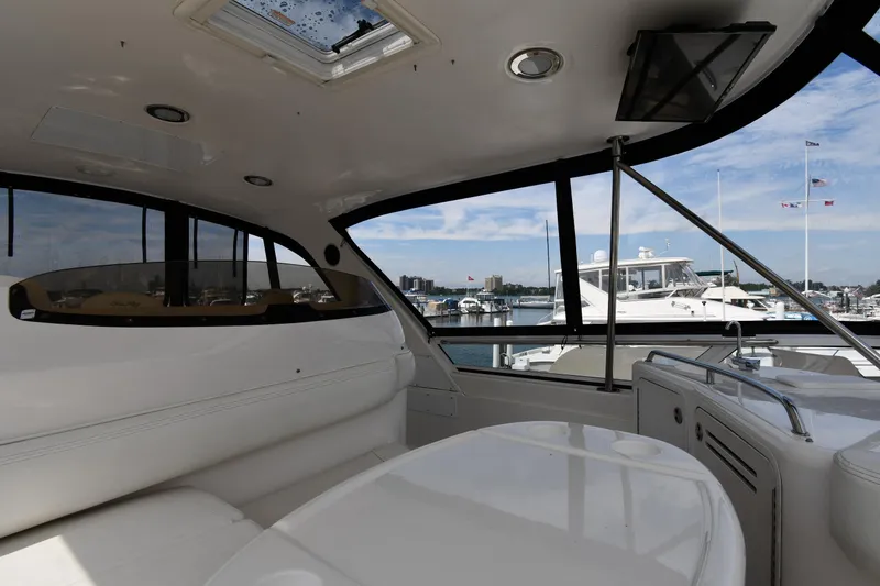 Slide: The Image of Interior view of 2001 Sea Ray 480 Sedan Bridge yacht with marina backdrop. - 32