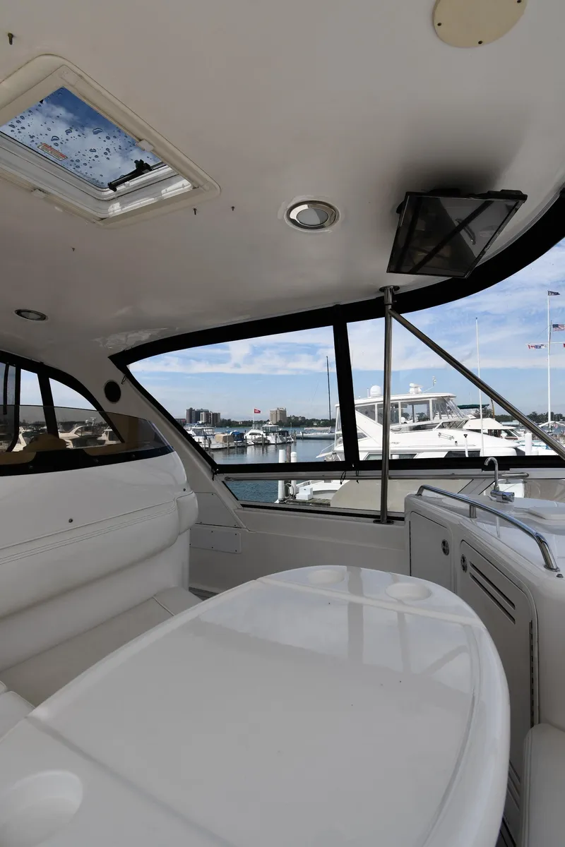 Slide: The Image of 2001 Sea Ray 480 Sedan Bridge interior with marina view through large windows. - 33