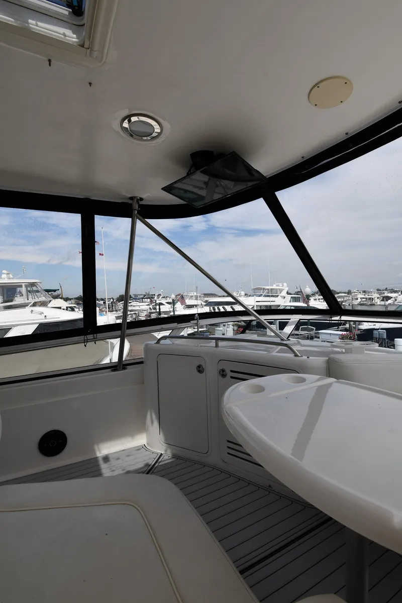 Slide: The Image of 2001 Sea Ray 480 Sedan Bridge interior with marina view. - 35