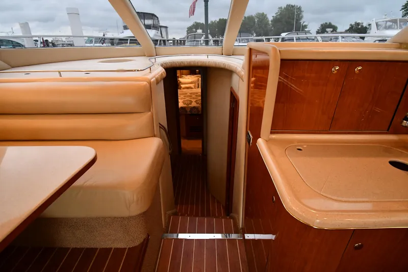Slide: The Image of Interior of 2001 Sea Ray 480 Sedan Bridge yacht with wood finishes and seating area. - 37