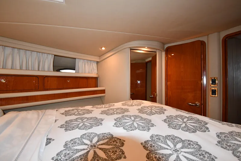 Slide: The Image of Interior cabin of 2001 Sea Ray 480 Sedan Bridge with floral bedding. - 45