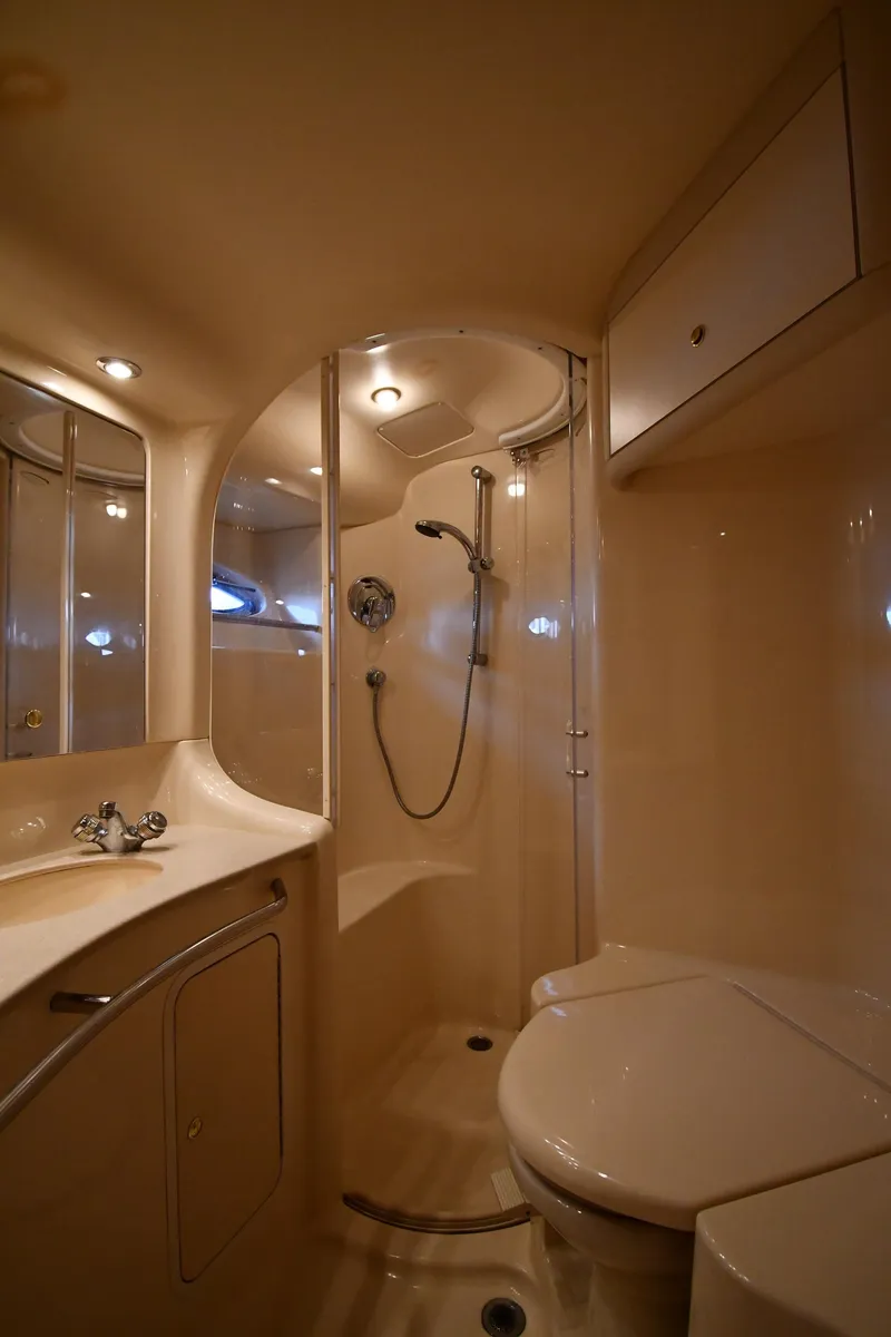 Slide: The Image of Luxurious bathroom in 2001 Sea Ray 480 Sedan Bridge yacht, featuring shower and vanity. - 48