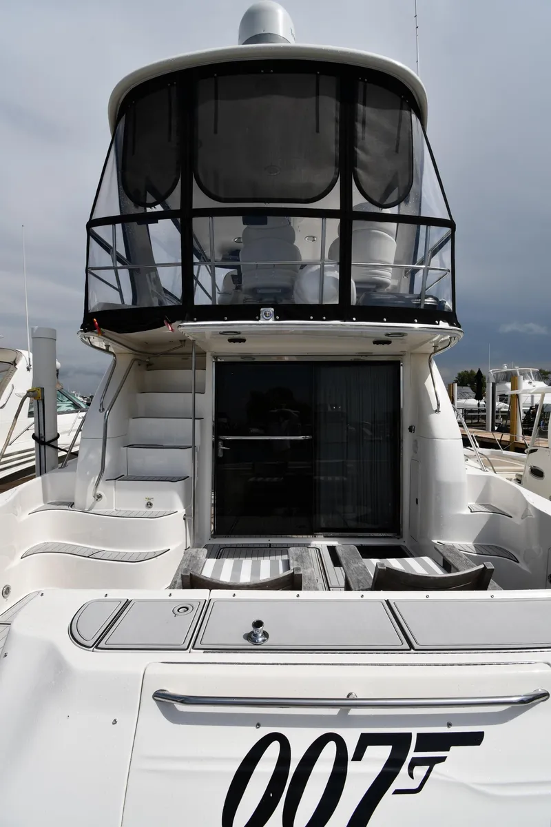 Slide: The Image of 2001 Sea Ray 480 Sedan Bridge yacht with distinctive "007" logo at the stern. - 7