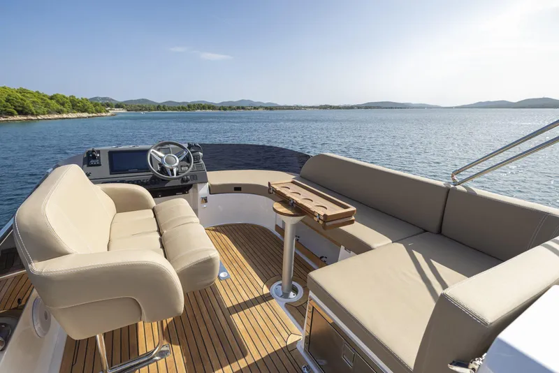 Slide: The Image of Luxurious 2025 Nimbus 405 Flybridge yacht interior with plush seating and scenic ocean view. - 2