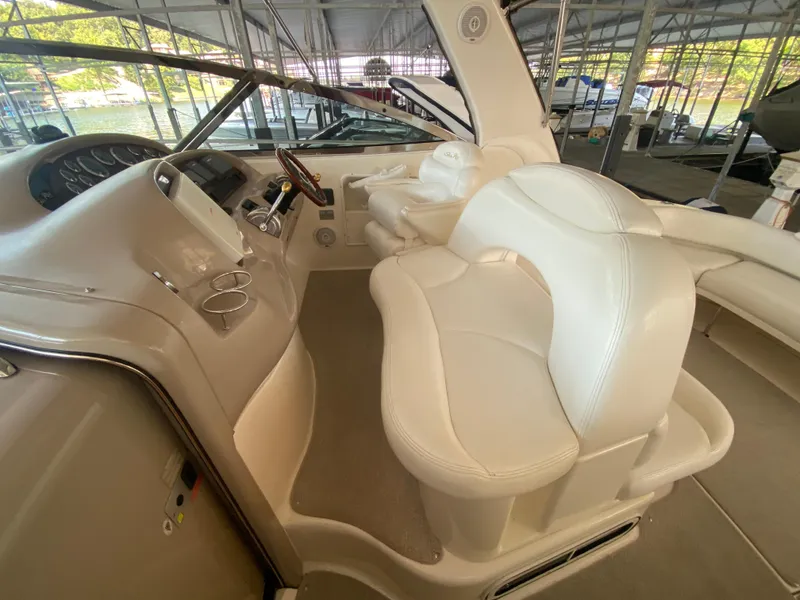 Slide: The Image of 1999 Sea Ray 380 Sundancer helm with white leather seating and steering wheel. - 13