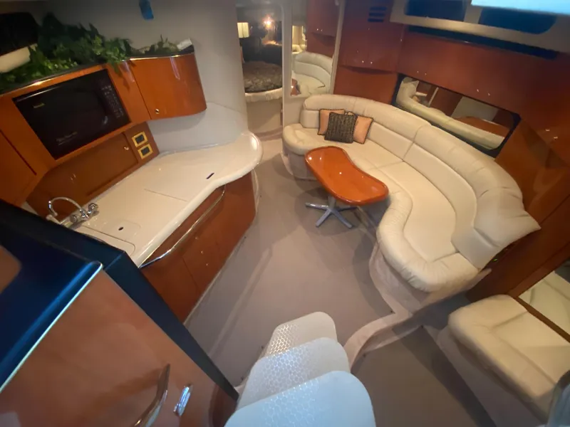Slide: The Image of Luxurious interior of 1999 Sea Ray 380 Sundancer with plush seating and modern amenities. - 19