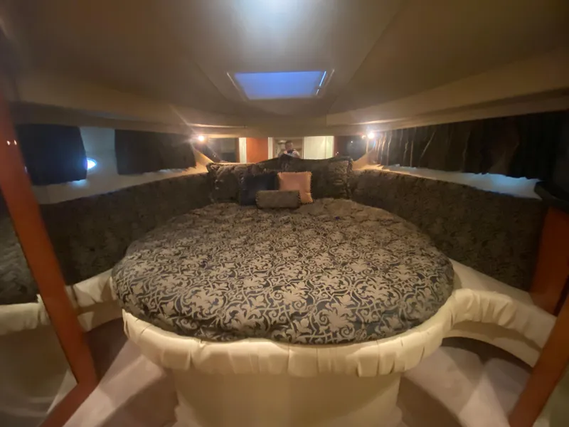 Slide: The Image of Luxurious cabin interior of 1999 Sea Ray 380 Sundancer with elegant bedding and ambient lighting. - 25