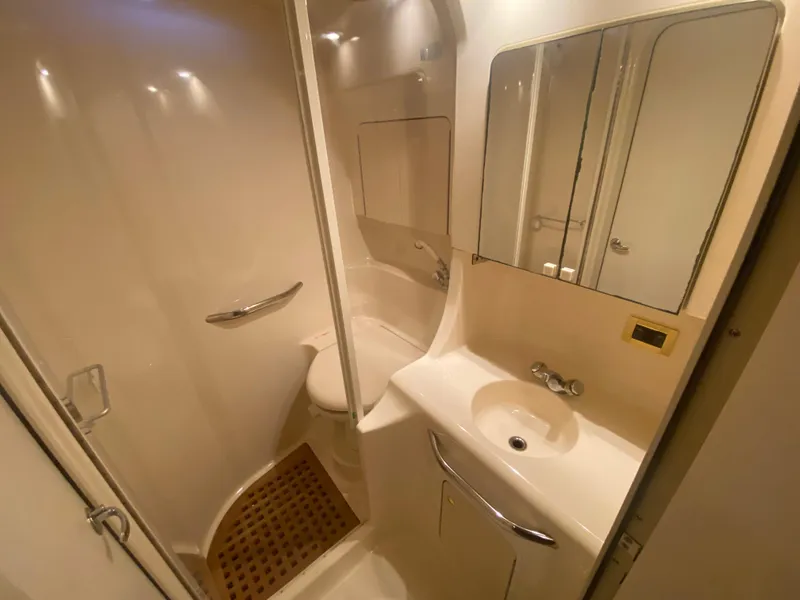 Slide: The Image of Bathroom interior of 1999 Sea Ray 380 Sundancer yacht, featuring shower and sink. - 30