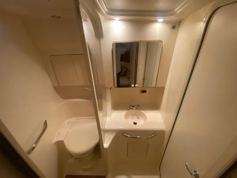 Slide: The Image of 1999 Sea Ray 380 Sundancer bathroom with sink, mirror, and toilet. - 31