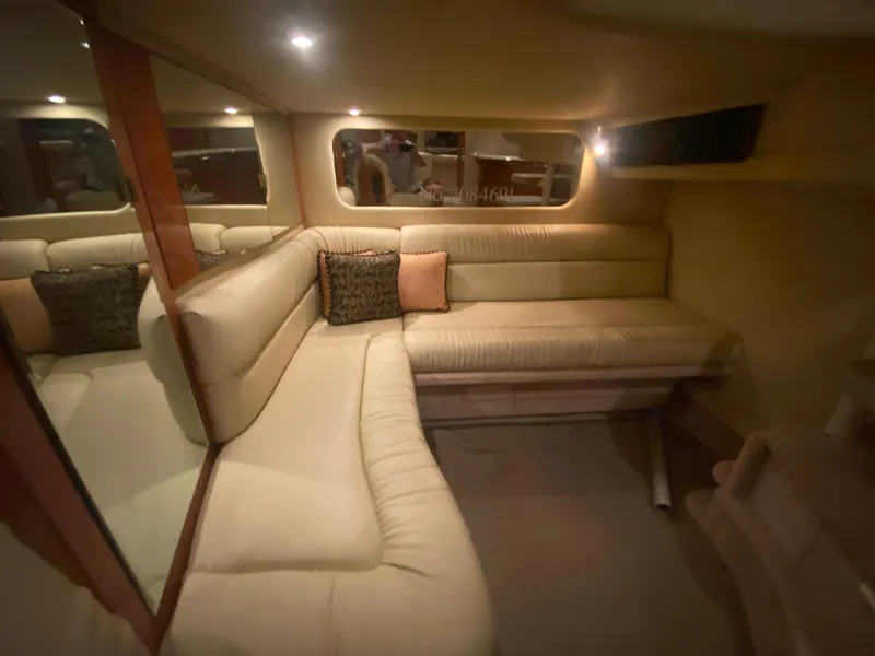Slide: The Image of Interior of 1999 Sea Ray 380 Sundancer yacht with beige seating and cushions. - 32