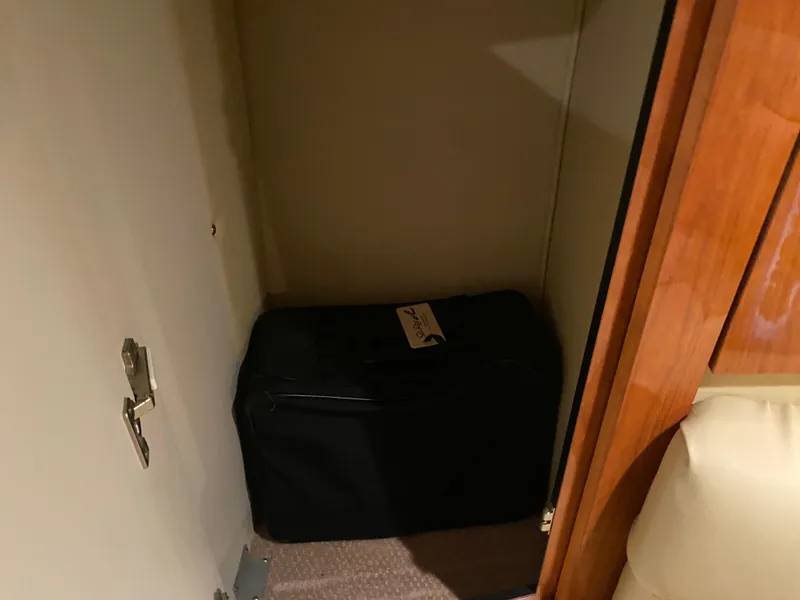 Slide: The Image of Storage compartment with luggage inside a 1999 Sea Ray 380 Sundancer boat. - 34
