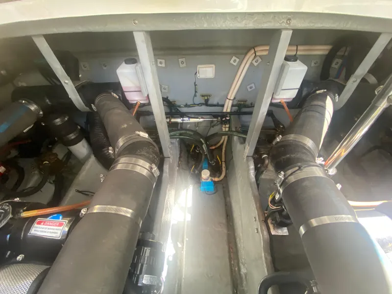 Slide: The Image of Engine room of a 1999 Sea Ray 380 Sundancer with visible hoses and components. - 41