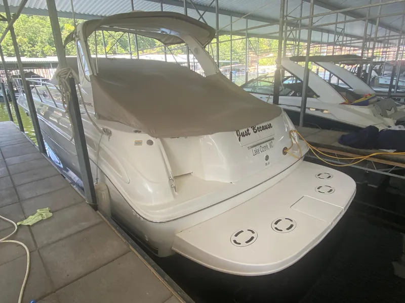 Slide: The Image of 1999 Sea Ray 380 Sundancer docked in covered marina, rear view. - 42