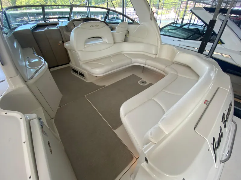 Slide: The Image of 1999 Sea Ray 380 Sundancer interior with white seating and helm station. - 7
